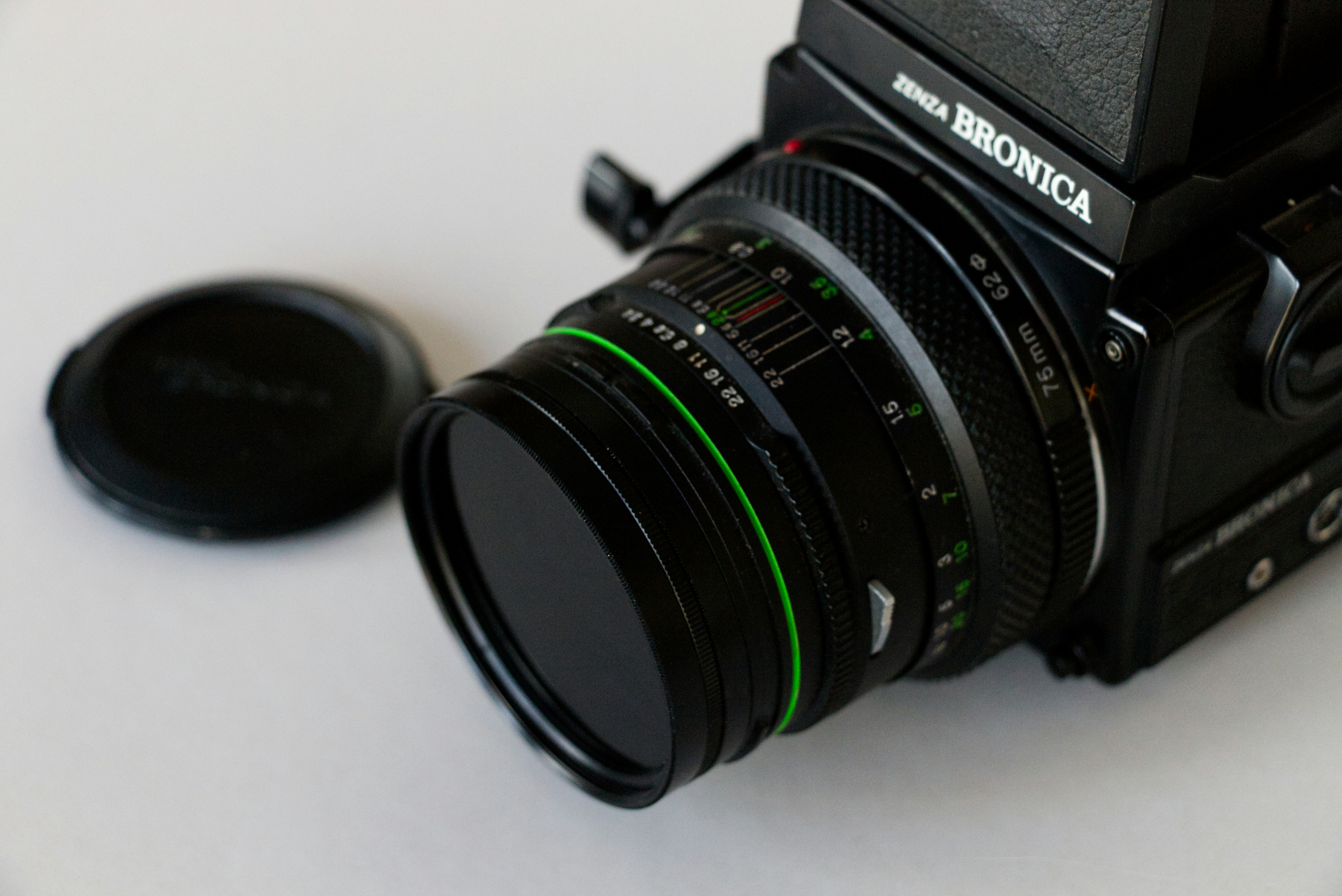 black nikon dslr camera on white table